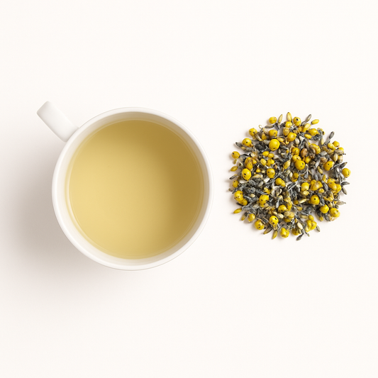 Steam rising from a calming lavender and chamomile tea beside dried flowers; herbal nighttime tea for skin repair and relaxation