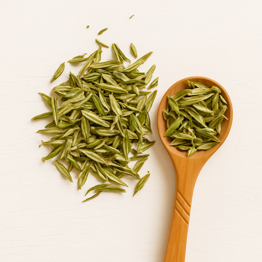 Delicate white tea infusion in a clear cup surrounded by white tea leaves; skin-protective antioxidant tea with gentle energy
