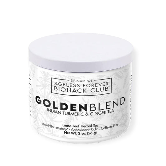 Golden-hued cup of turmeric and ginger tea with scattered roots; anti-inflammatory tea for radiant, calm skin