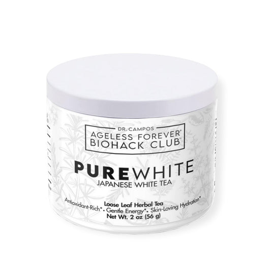 Delicate white tea infusion in a clear cup surrounded by white tea leaves; skin-protective antioxidant tea with gentle energy