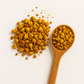 Golden-hued cup of turmeric and ginger tea with scattered roots; anti-inflammatory tea for radiant, calm skin