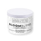 Glass cup of BloomBlend hibiscus and peppermint tea beside loose leaves; vibrant herbal tea for skin clarity and anti-inflammatory benefits